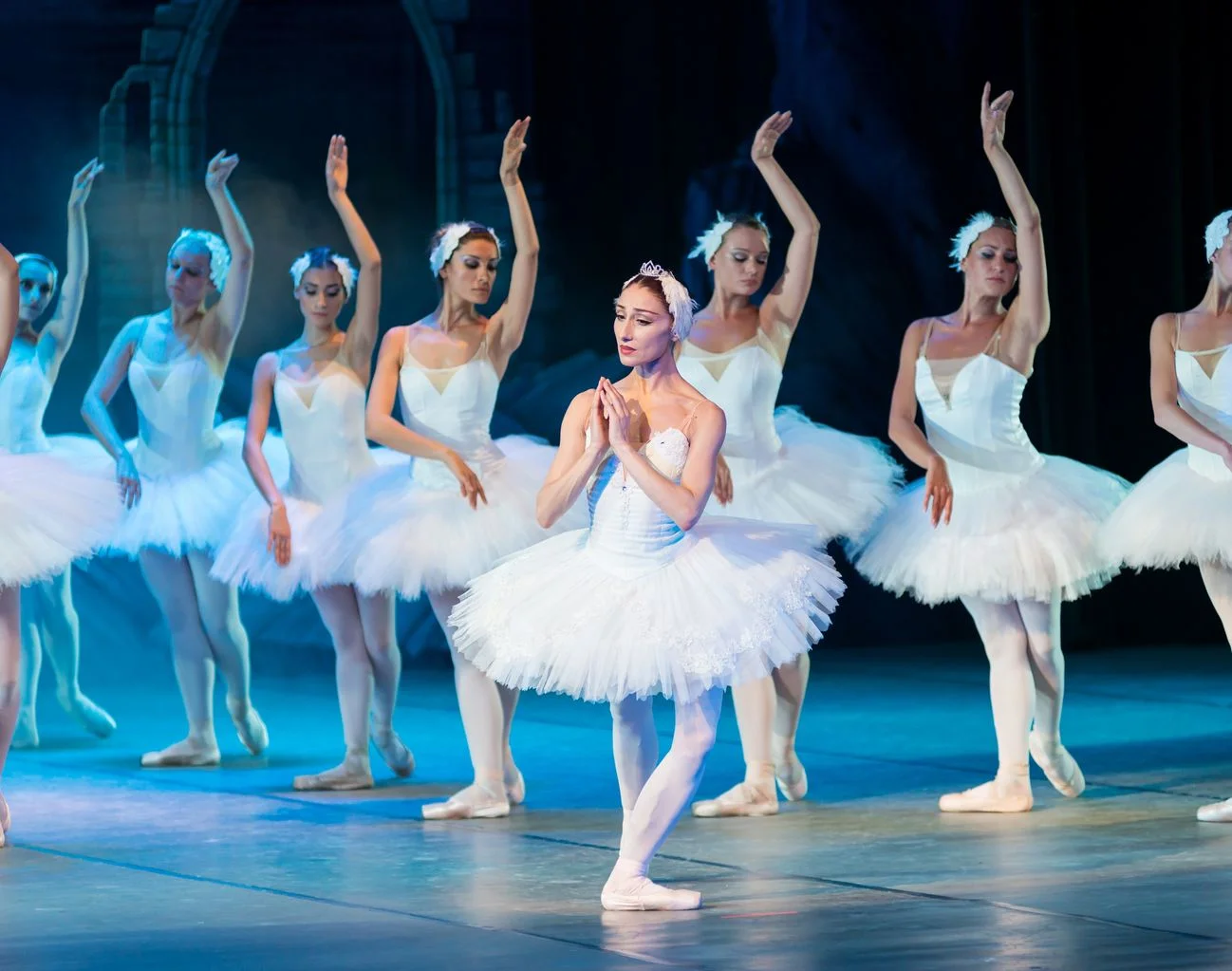 Female dancers performing a synchronised choreographed phrase in a stage show