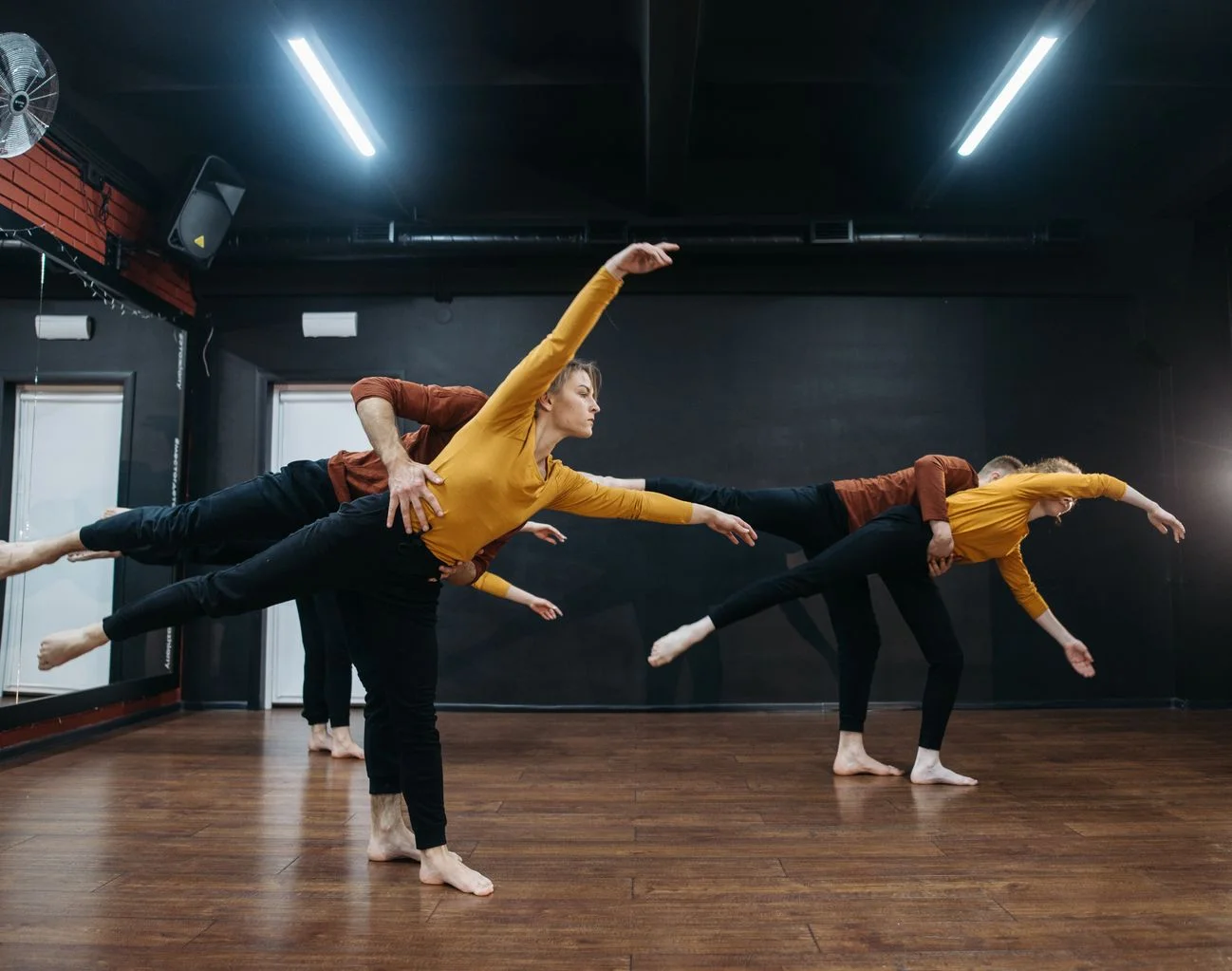 Dancers rehearsing event choreography together in a dance studio