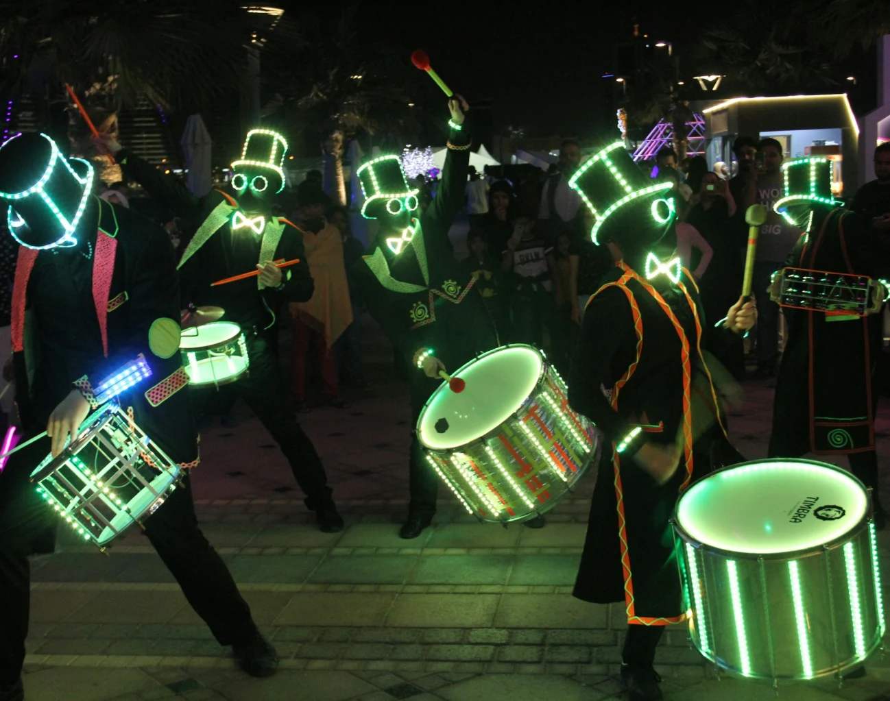 LED costume performers in glowing outfits at a night show
