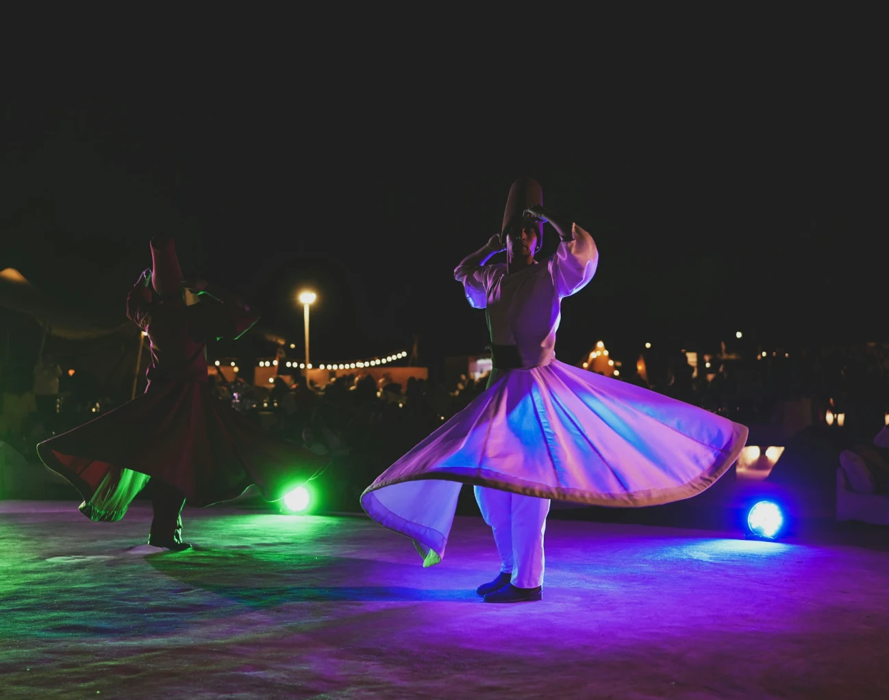 Dance performer under dramatic venue lighting during a show